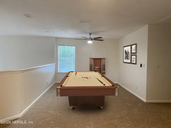 a room with pool table and flat screen tv