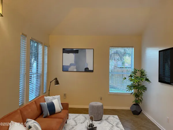 a living room with furniture potted plant and a window