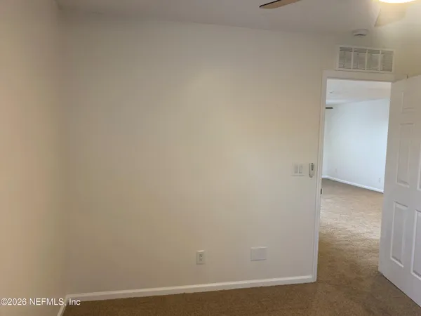 a bedroom with furniture and a large window