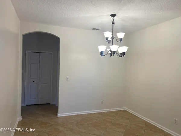 a view of a chandelier fan and hardwood floor