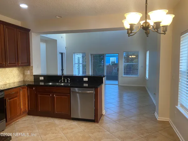 a kitchen with stainless steel appliances granite countertop a sink and cabinets