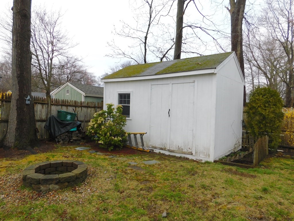 44 Delmar Road Brockton, MA 02302 - Photo 18 of 19 a backyard of a house with yard and tree