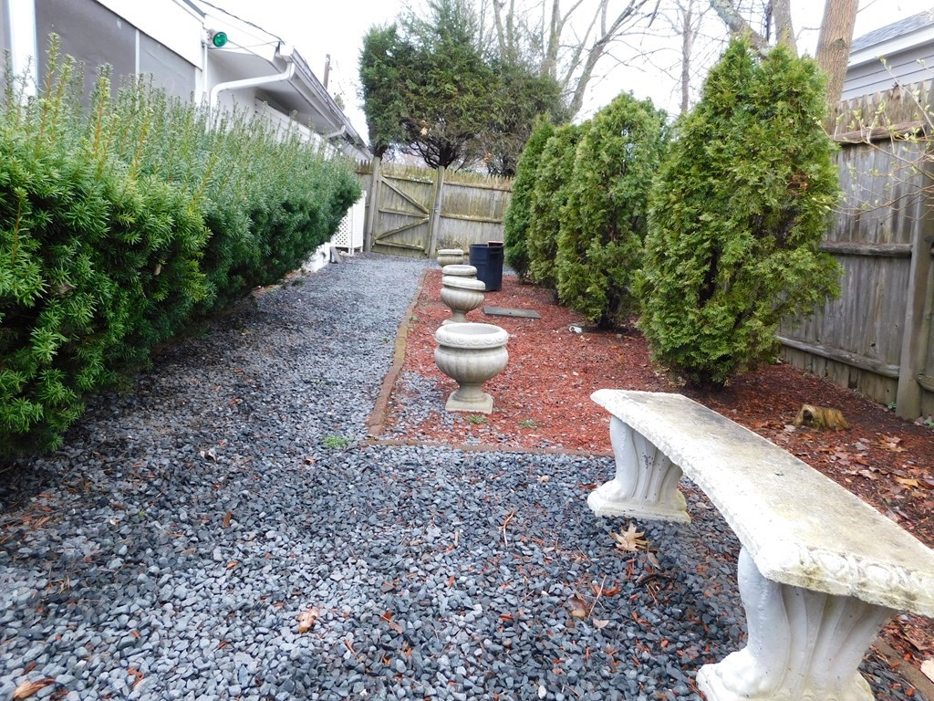 44 Delmar Road Brockton, MA 02302 - Photo 19 of 19 a view of a yard with plants and wooden fence