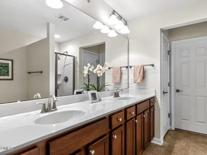 a bathroom with a sink double vanity and a mirror