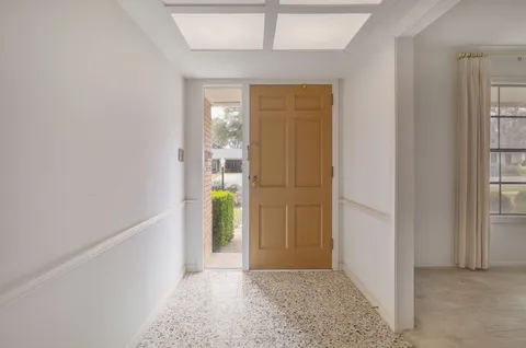 a view of empty room with a window and a ceiling fan