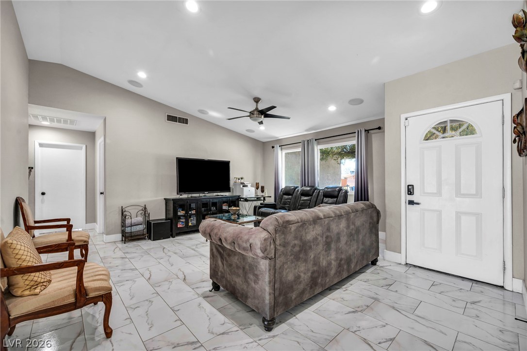 5882 Rio Tinto Way Las Vegas, NV 89110 - Photo 36 of 56 Step into this luminous living space featuring high vaulted ceilings and sleek tile flooring throughout.