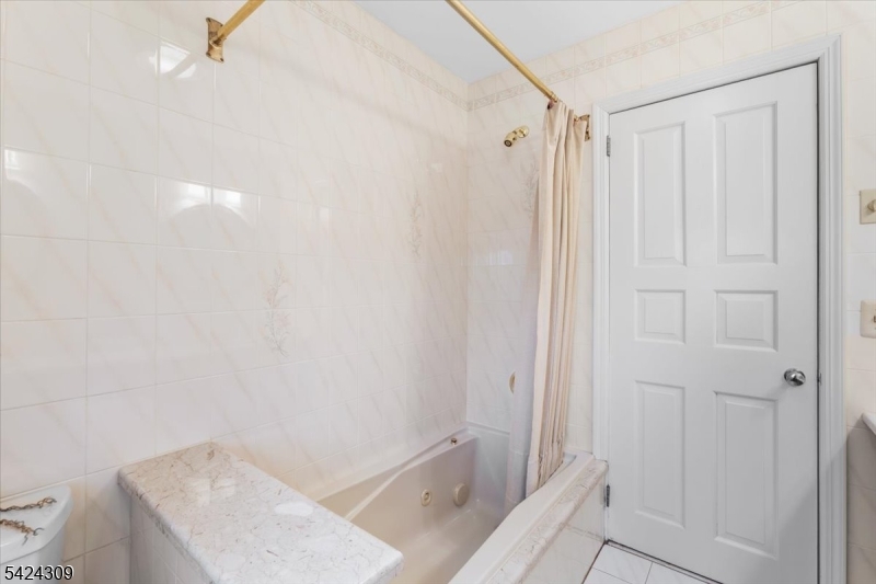 58 Andover Road Sparta, NJ 07871 - Photo 21 of 38 a bathroom with a shower and a tub