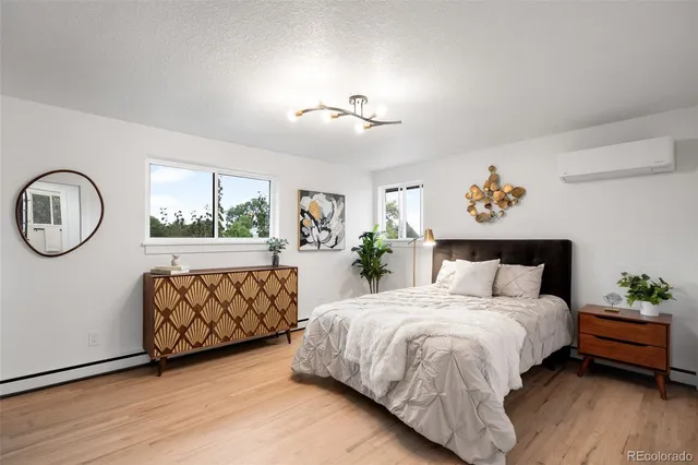 a bedroom with a bed mirror and window