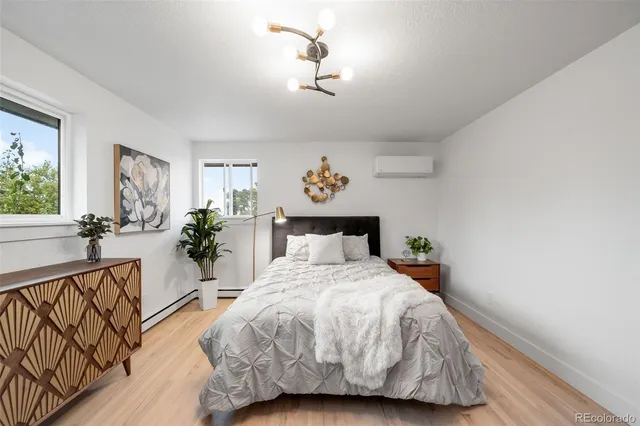 a bed room with a bed and a chandelier