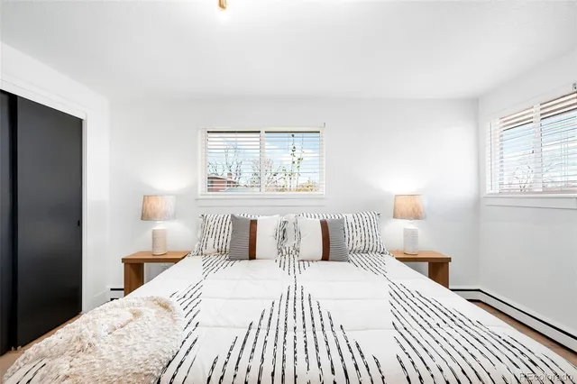 a bedroom with a large bed and a window