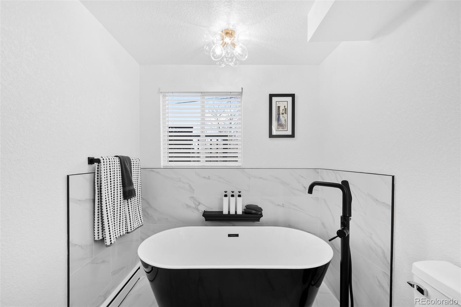 3860 Dudley Street Wheat Ridge, CO 80033 - Photo 20 of 35 a bathroom with a sink and a mirror