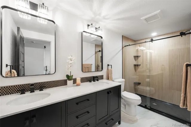 a bathroom that has a shower toilet and sink