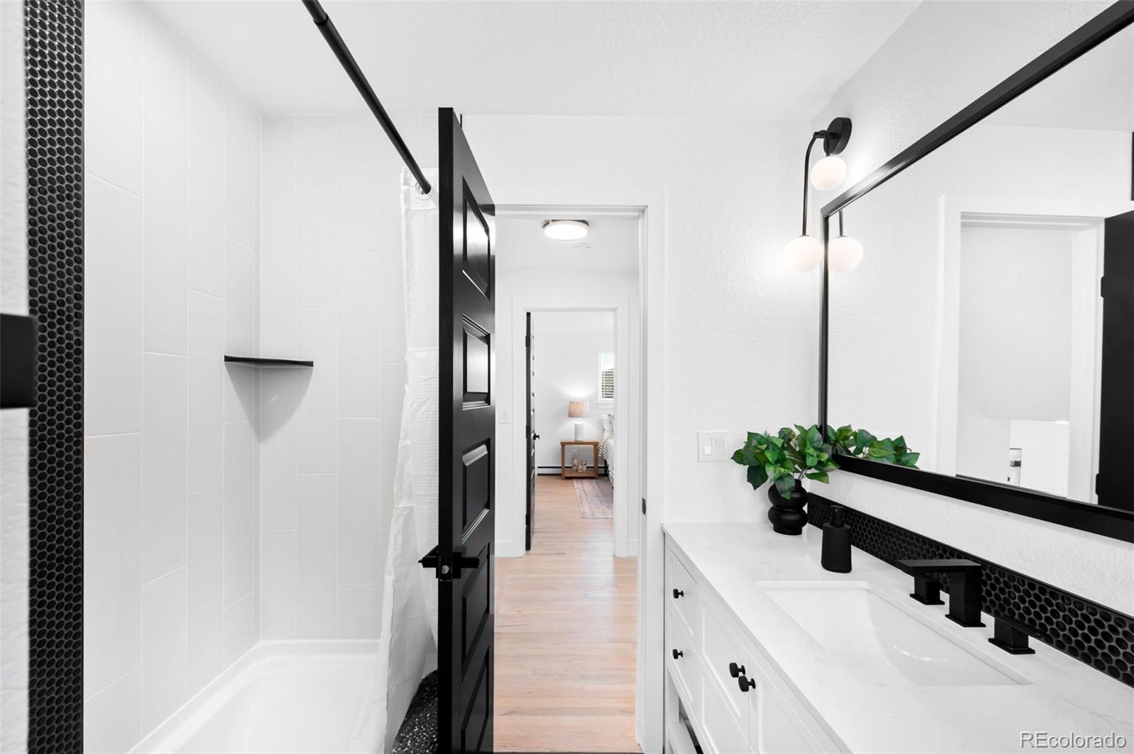 3860 Dudley Street Wheat Ridge, CO 80033 - Photo 25 of 35 a bathroom with a bathtub and a sink