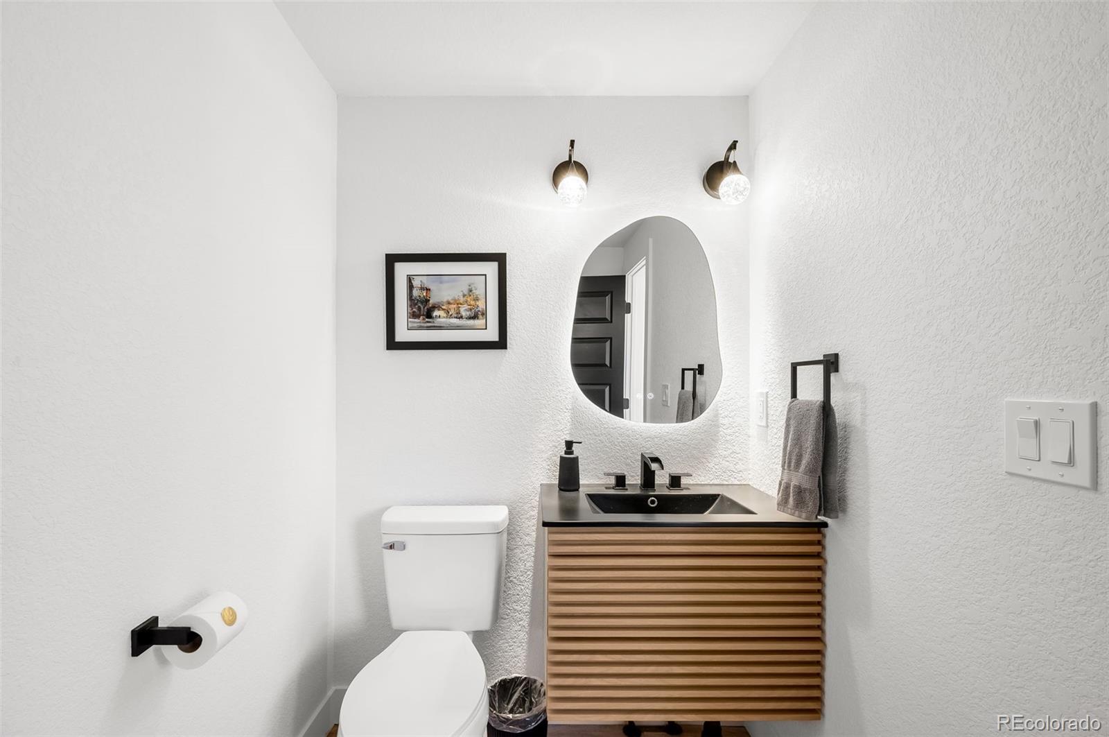 3860 Dudley Street Wheat Ridge, CO 80033 - Photo 28 of 35 a bathroom with a toilet a sink and mirror