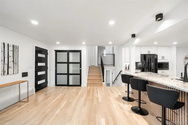 a view of a workspace with furniture and a kitchen