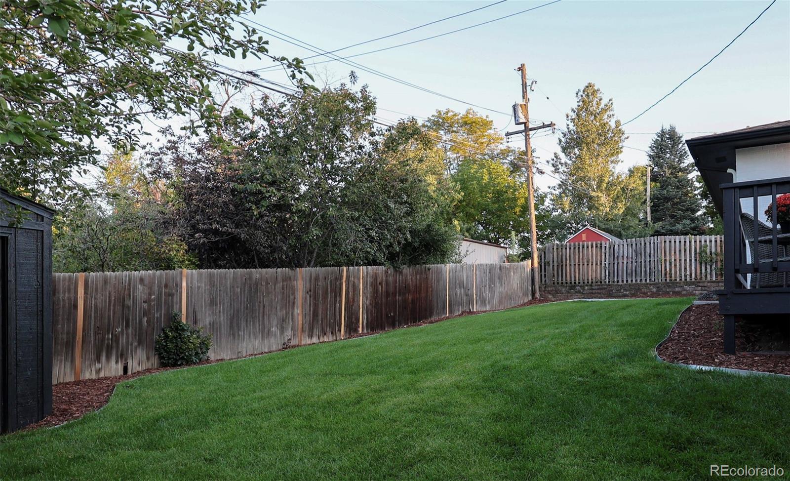 3860 Dudley Street Wheat Ridge, CO 80033 - Photo 31 of 35 a backyard of a house with lots of green space