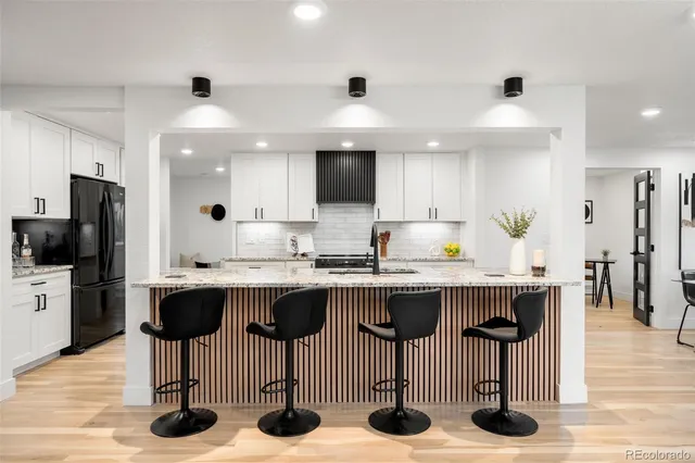 a kitchen with stainless steel appliances kitchen island granite countertop a sink and cabinets