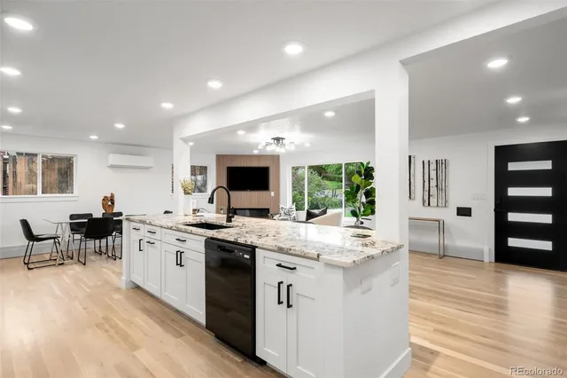 a large kitchen with stainless steel appliances kitchen island granite countertop a large cabinets and sink
