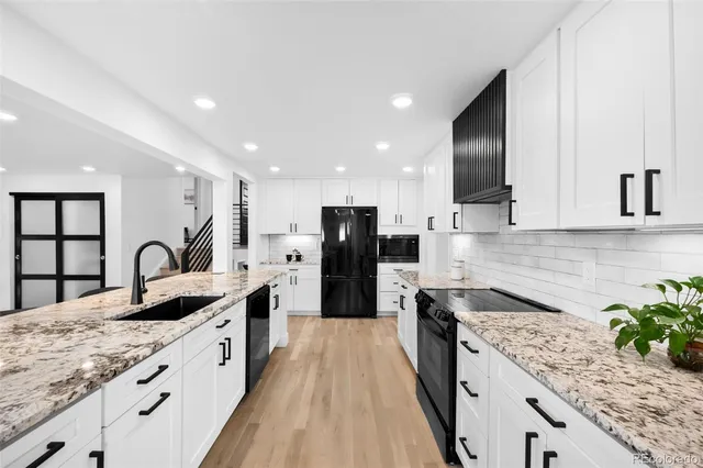 a kitchen with stainless steel appliances kitchen island granite countertop a sink and cabinets