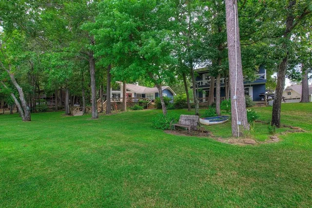 a view of a chair and table in backyard of the house