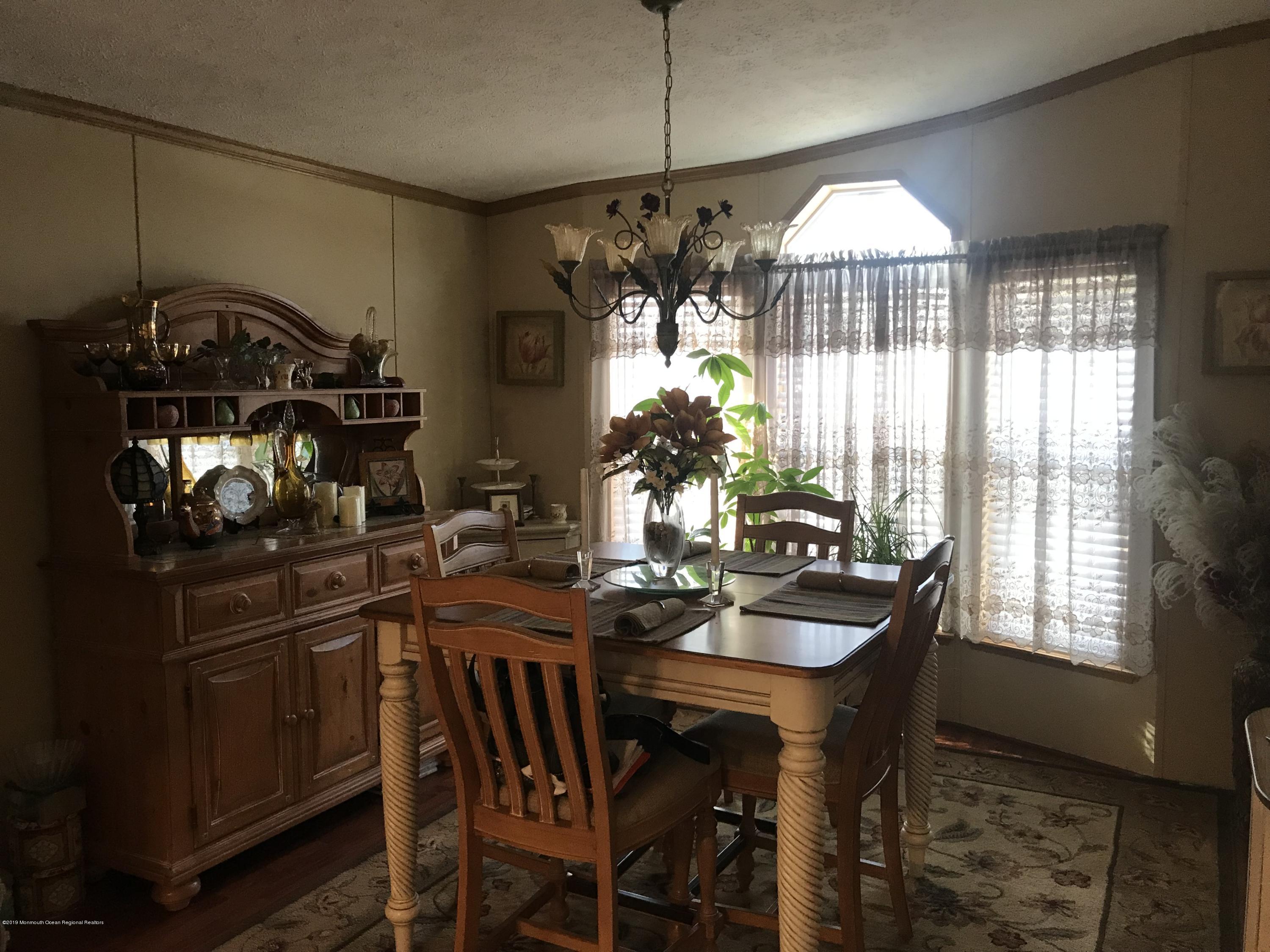 204 Roberts Road Toms River, NJ 08755 - Photo 12 of 19 a view of a dining room with furniture and chandelier