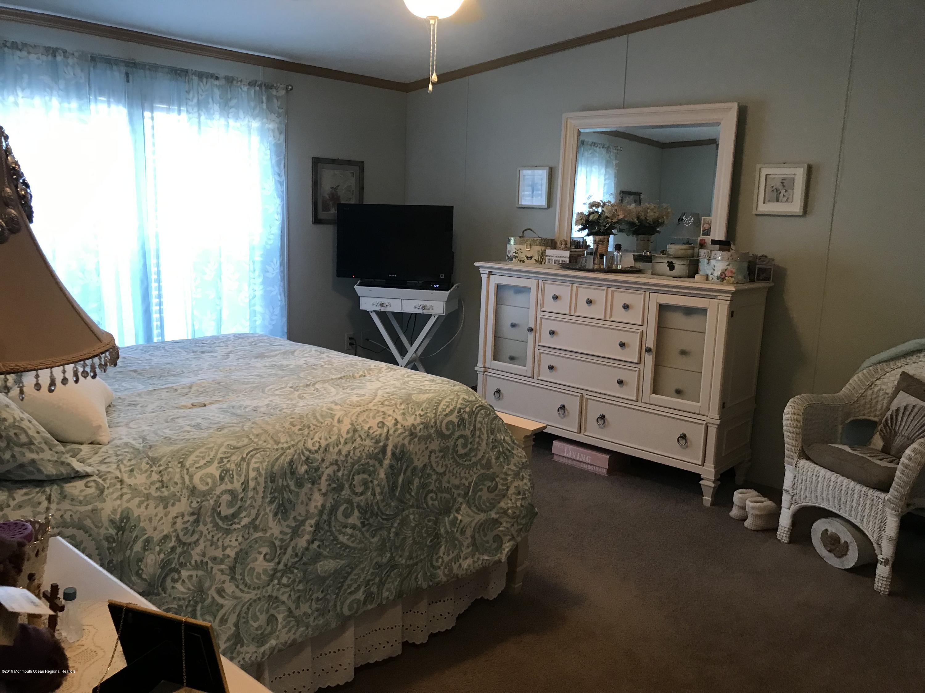 204 Roberts Road Toms River, NJ 08755 - Photo 15 of 19 a bedroom with a bed and a television in it