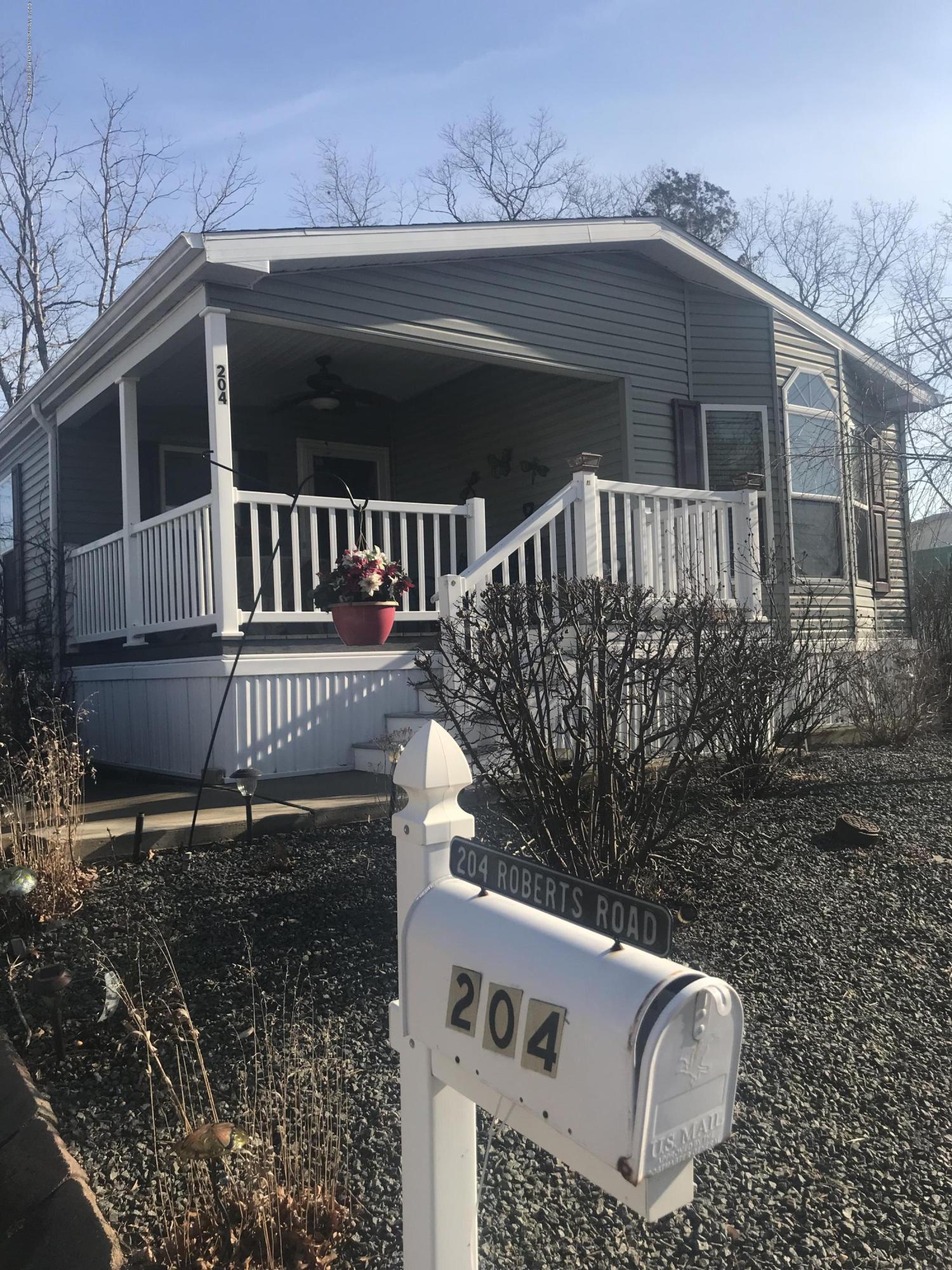 204 Roberts Road Toms River, NJ 08755 - Photo 3 of 19 a view of a house with a small yard and wooden fence