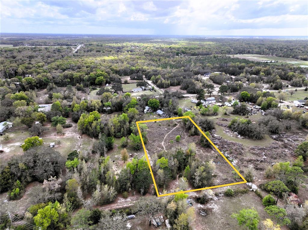 17783 Bonifay Lane Spring Hill, FL 34610 - Photo 8 of 9 an aerial view of a residential houses with outdoor space and trees