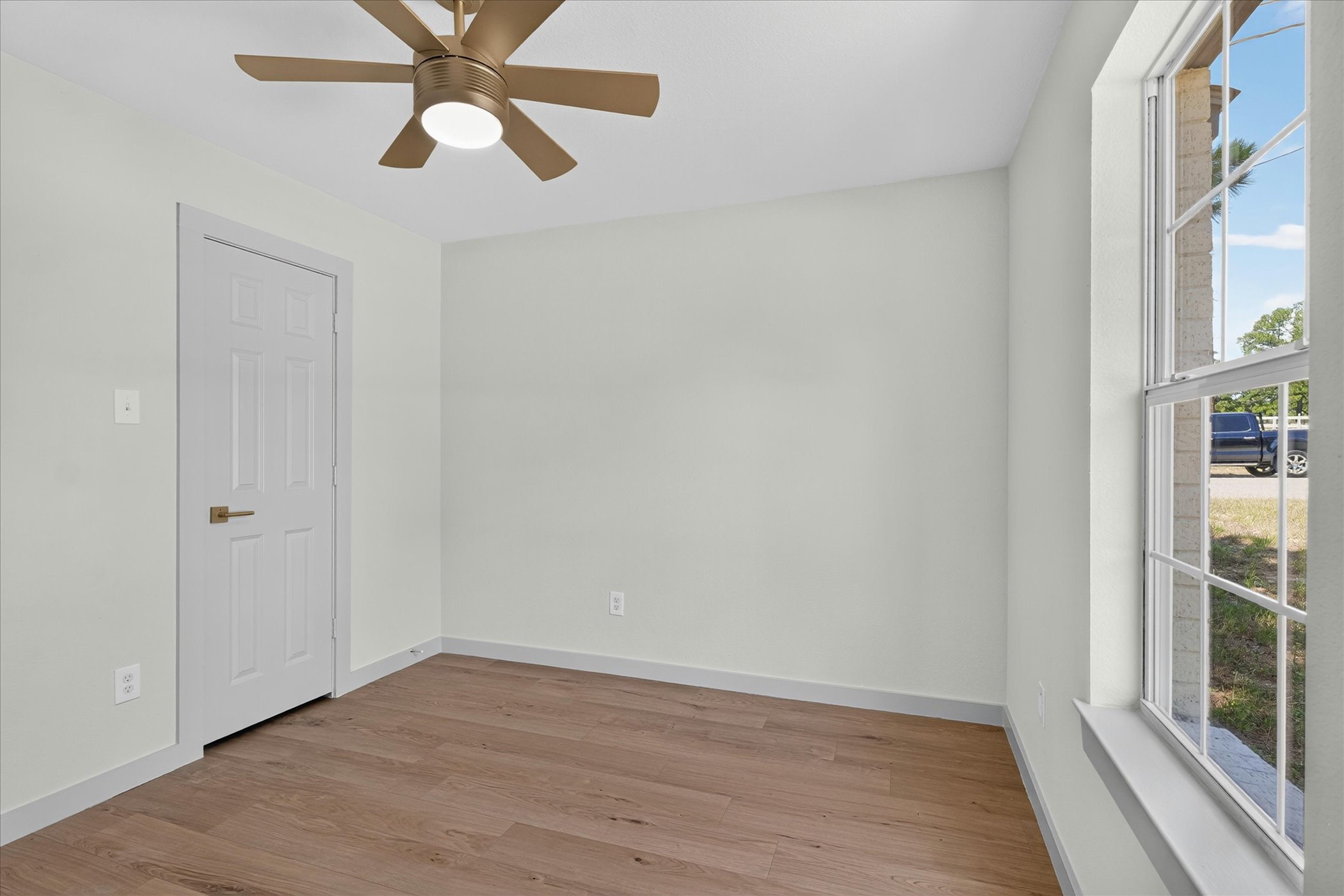258 Pine View Loop Bastrop, TX 78602 - Photo 37 of 40 A quiet bedroom featuring rich hardwood flooring and a stylish ceiling fan.