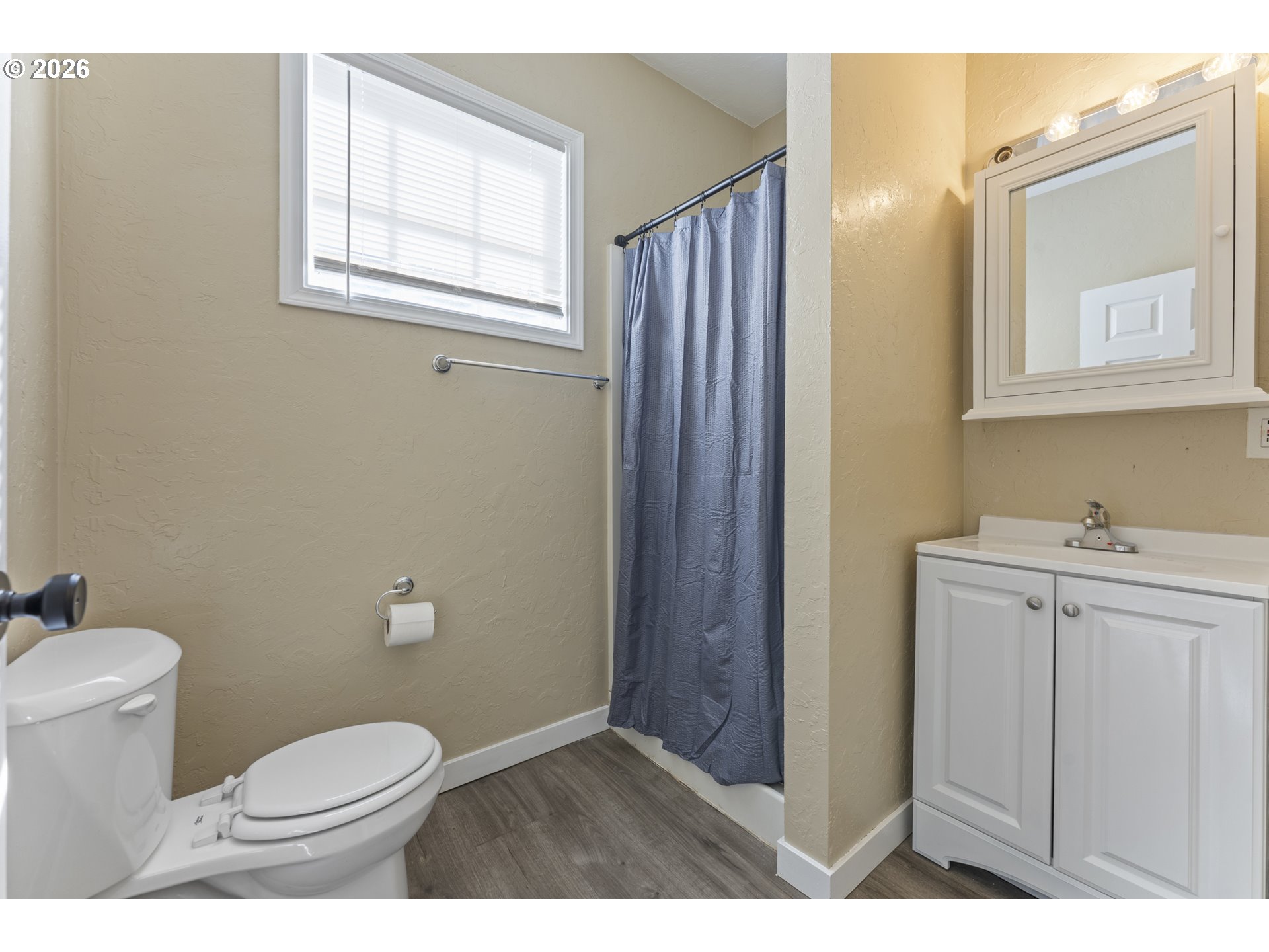 7915 North Exeter Avenue Portland, OR 97203 - Photo 26 of 34 a bathroom with a toilet a sink a vanity and mirror