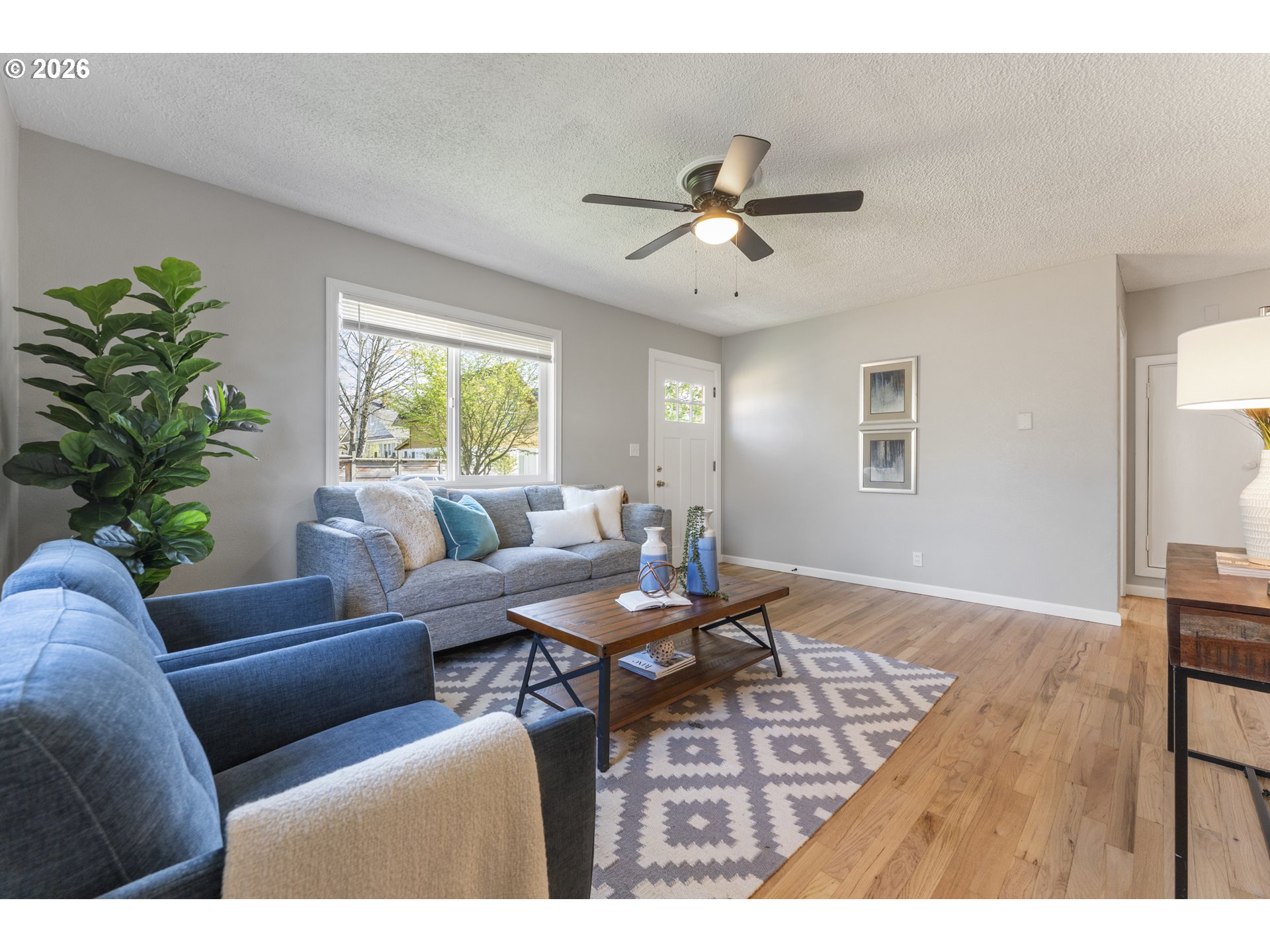 7915 North Exeter Avenue Portland, OR 97203 - Photo 5 of 34 a living room with furniture a window and a potted plant