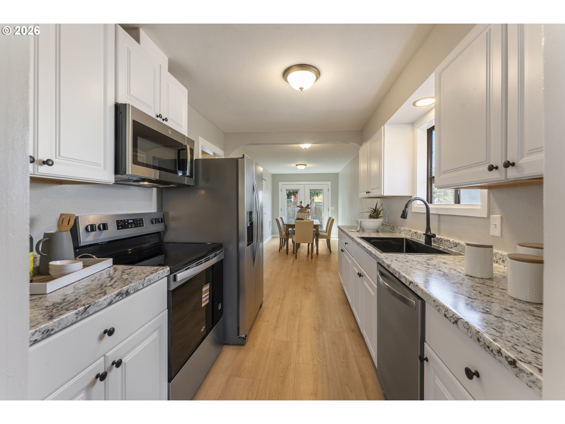 7915 North Exeter Avenue Portland, OR 97203 - Photo 8 of 34 a large kitchen with stainless steel appliances granite countertop a stove sink and cabinets