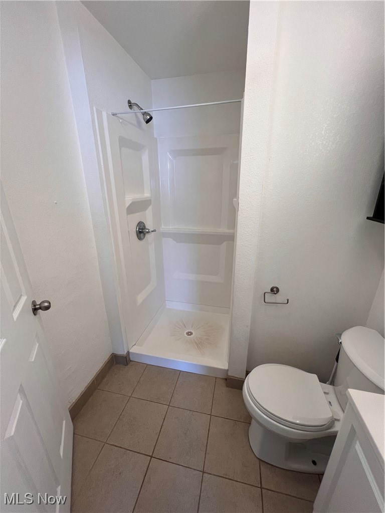 1724 Youngstown Kingsville Road, Unit 4 Vienna, OH 44473 - Photo 8 of 11 Full bath featuring tile patterned floors, a stall shower, baseboards, and toilet