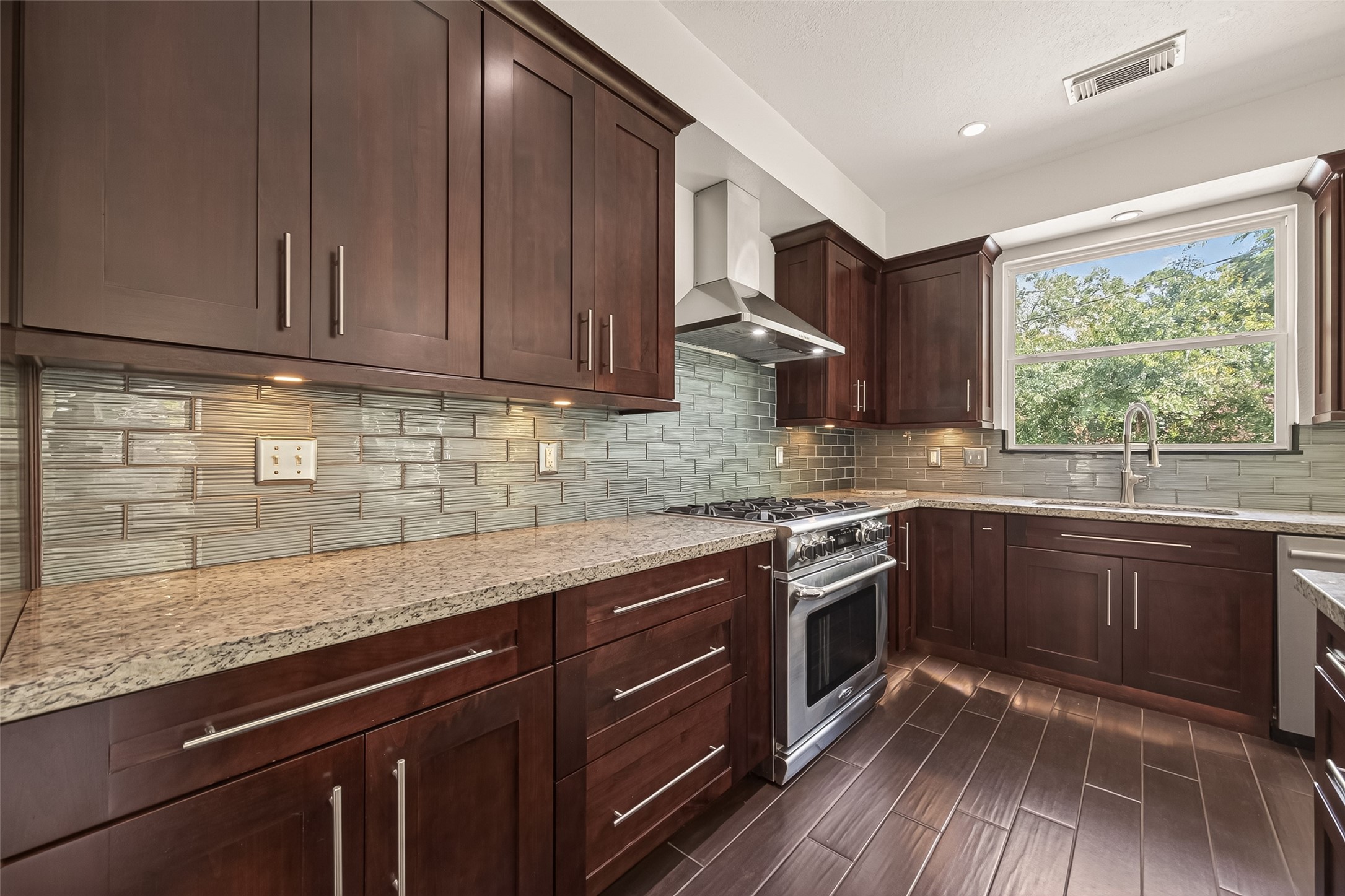 6131 Hampton Way Court Spring, TX 77389 - Photo 20 of 50 a kitchen with stainless steel appliances granite countertop wooden cabinets and a counter top space