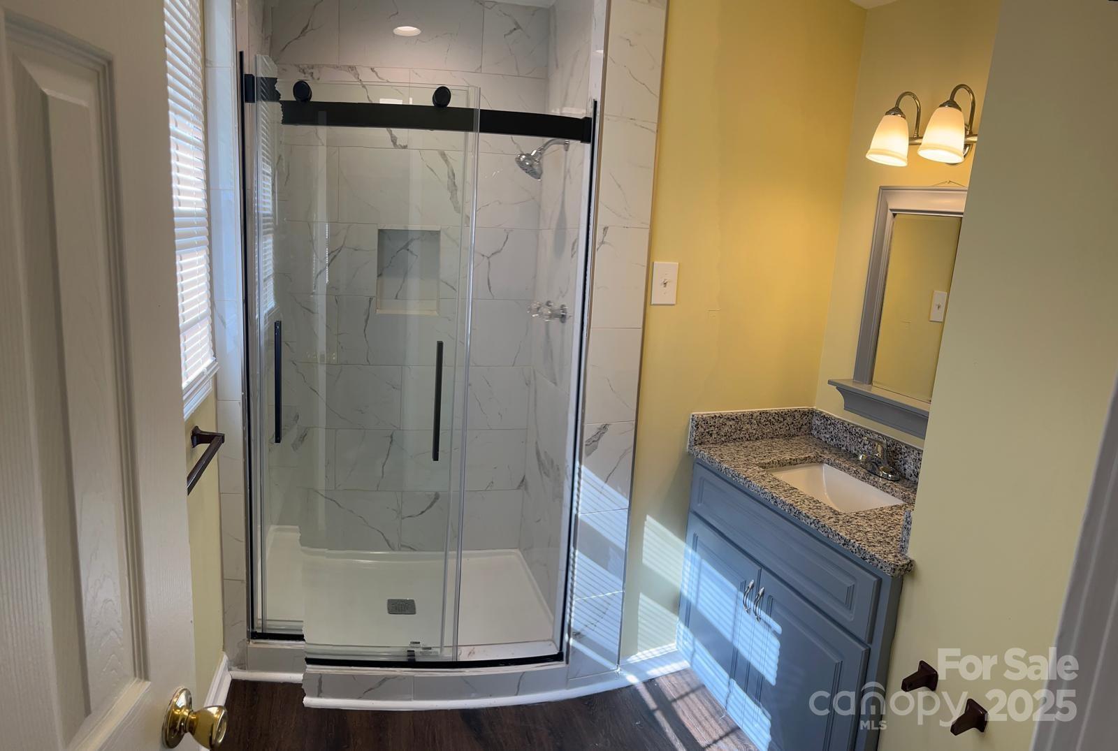 104 Edison Street Kings Mountain, NC 28086 - Photo 19 of 28 a bathroom with a granite countertop shower a mirror and a sink