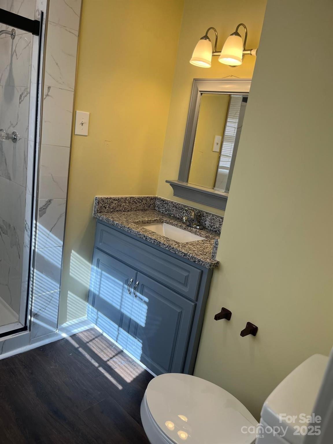 104 Edison Street Kings Mountain, NC 28086 - Photo 21 of 28 a bathroom with a granite countertop toilet sink and mirror