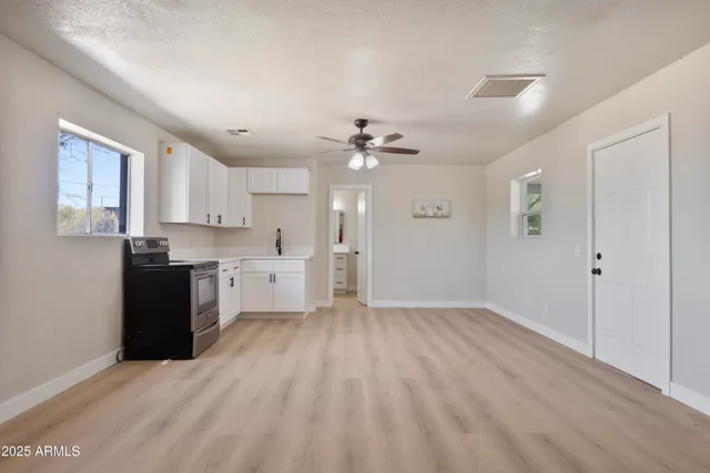 a view of a kitchen with a sink dishwasher a refrigerator and cabinets