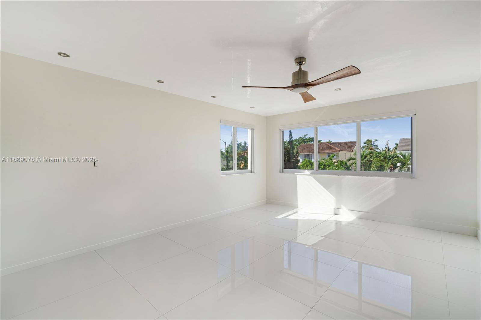 6763 Southwest 106th Place Miami, FL 33173 - Photo 16 of 38 a view of a room with a window and a ceiling fan