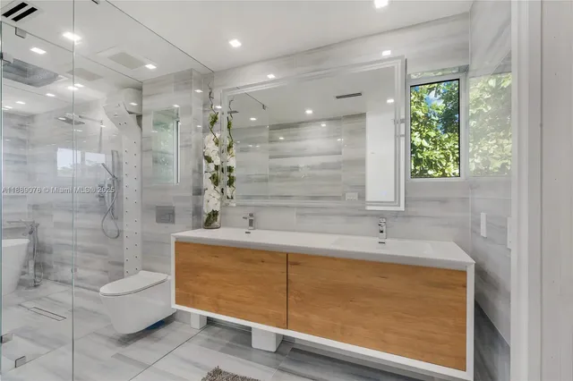 a bathroom with a sink a shower and a mirror