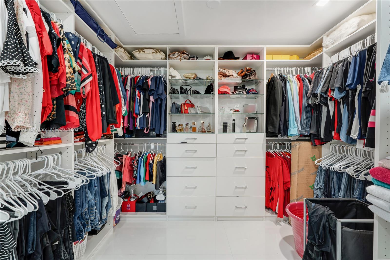 6763 Southwest 106th Place Miami, FL 33173 - Photo 22 of 38 a view of walk in closet with clothes