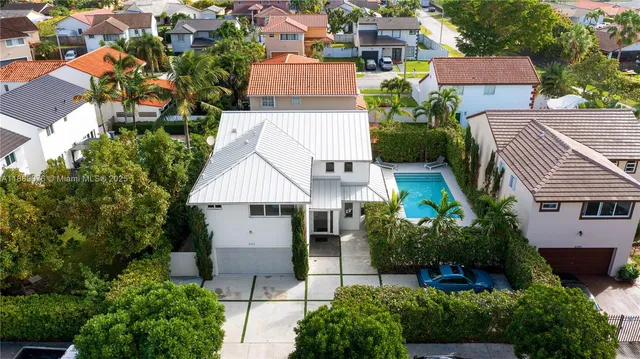 an aerial view of multiple houses with yard