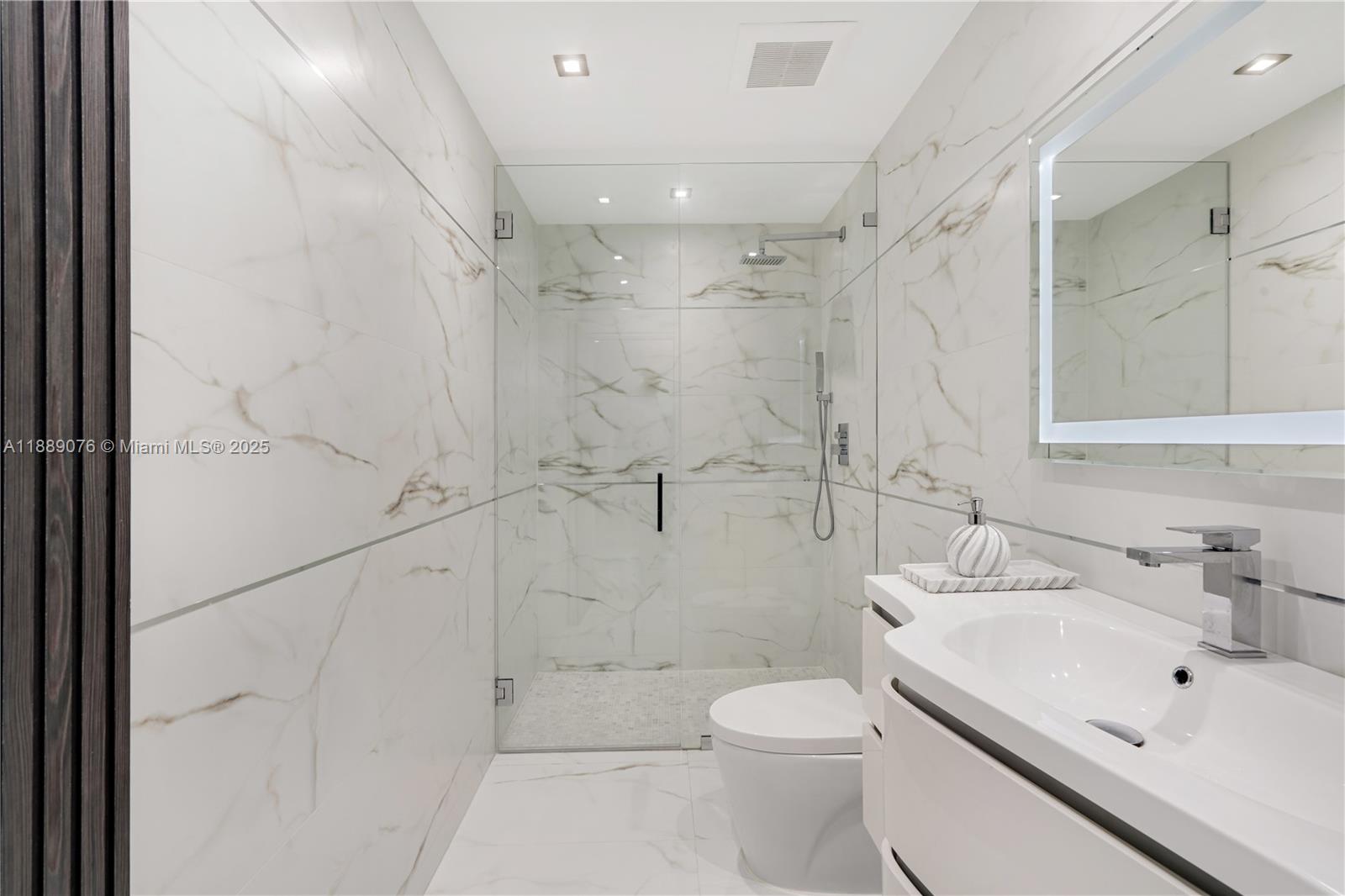 6763 Southwest 106th Place Miami, FL 33173 - Photo 10 of 38 a bathroom with a sink toilet and shower