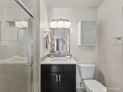 a bathroom with a toilet sink and mirror
