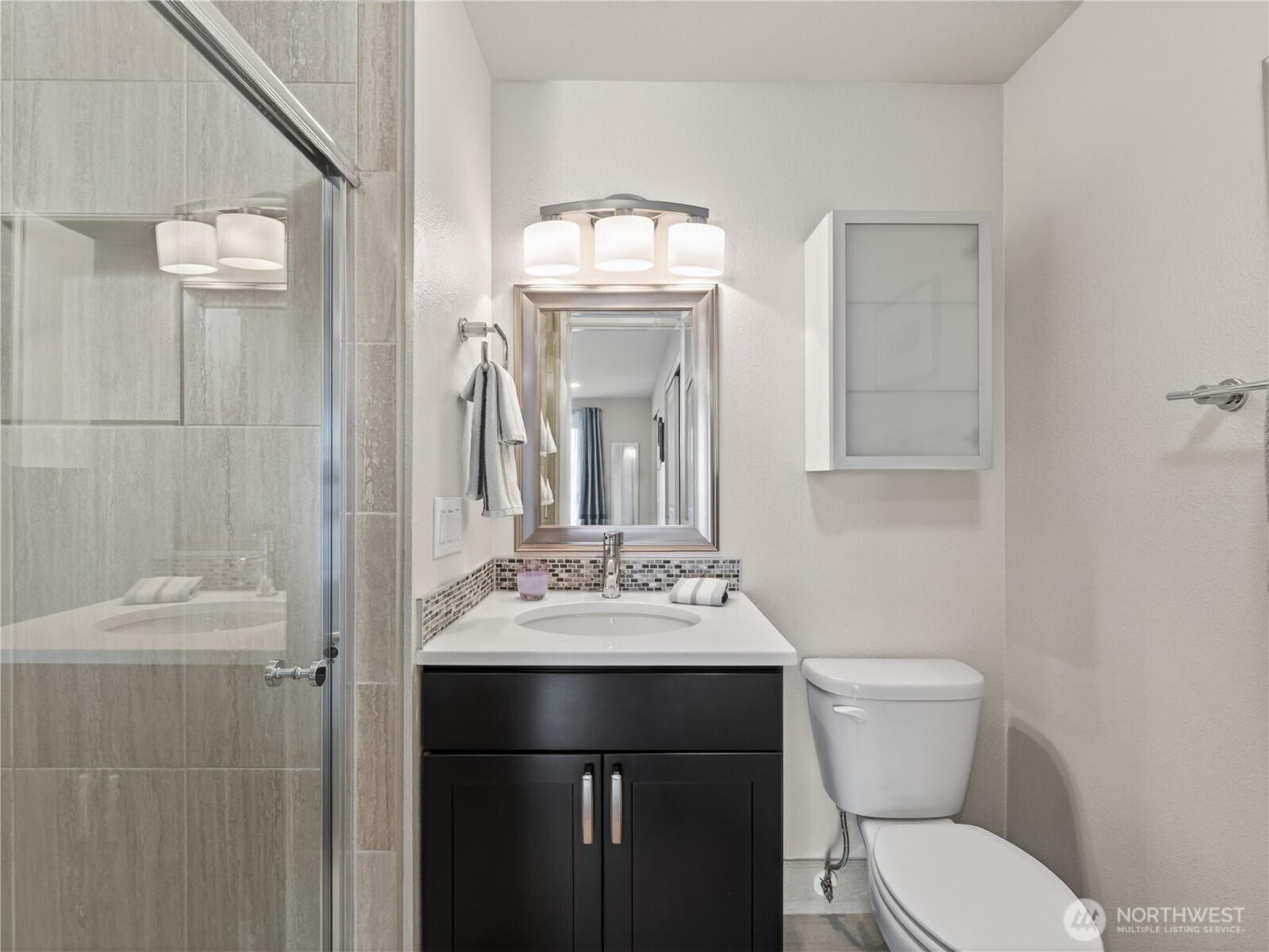 10203 47th Avenue Southwest, Unit C8 Seattle, WA 98146 - Photo 18 of 39 a bathroom with a toilet sink and mirror