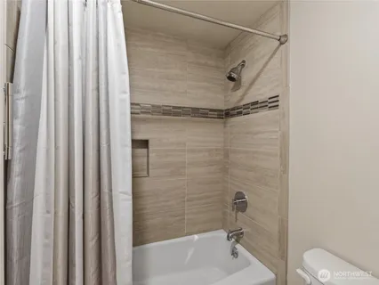 a bathroom with a shower and a toilet