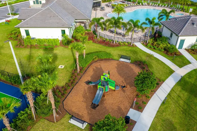 a kitchen with kitchen island granite countertop a sink and refrigerator