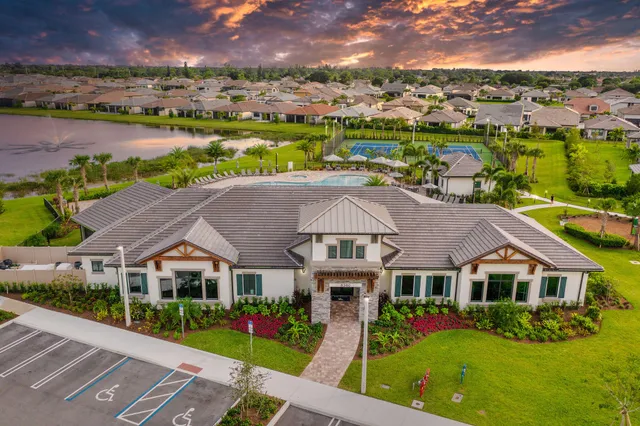 a large kitchen with a sink a counter top space stainless steel appliances and cabinets