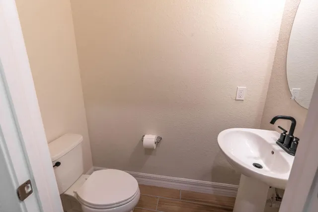 a bathroom with a granite countertop sink a mirror and a shower
