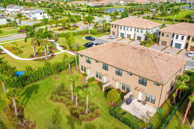 aerial view of a house with a yard and potted plants
