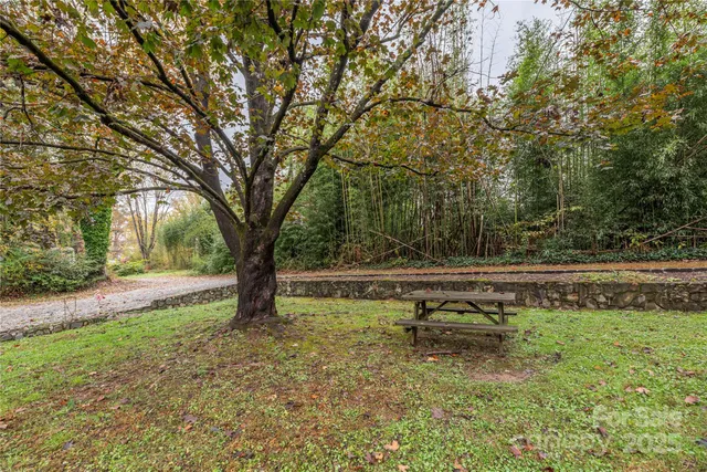 a view of a yard with wooden fence